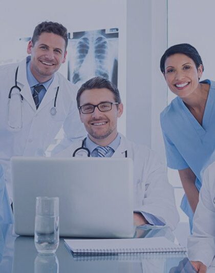 image of five medical providers in front of a computer
